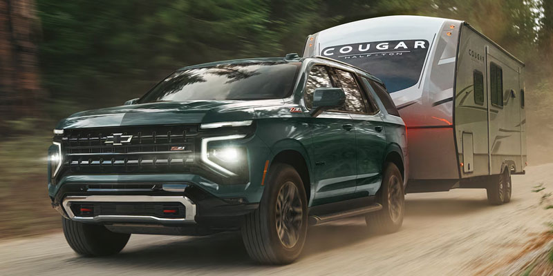 2026 Chevrolet Tahoe towing a camper in Miami, FL, showcasing its capability and versatility for outdoor adventures.
