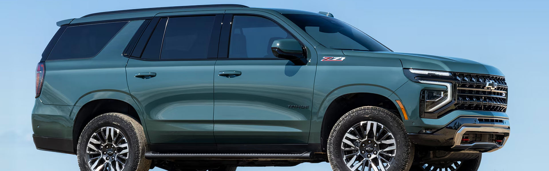 Green 2026 Chevrolet Tahoe SUV with distinctive front grille and modern LED lighting.